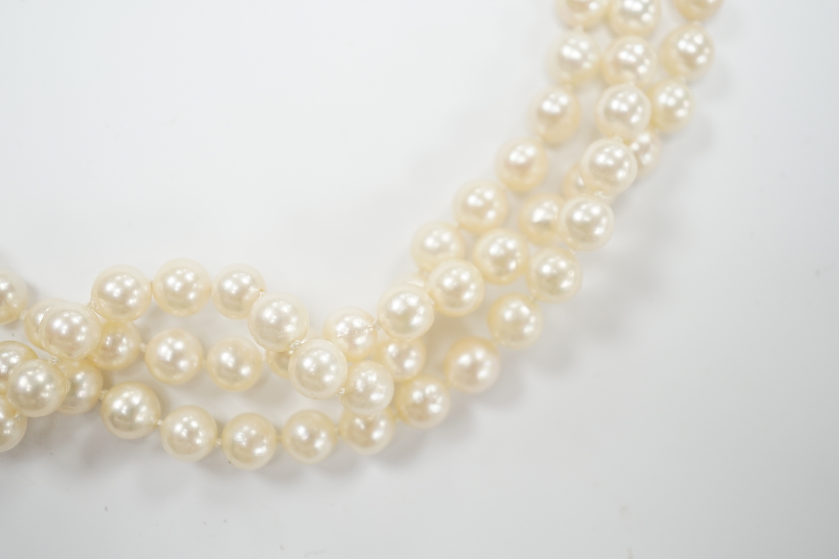 A triple strand cultured pearl set choker necklace, with 750 yellow metal and cultured pearl set clasp, 35cm.